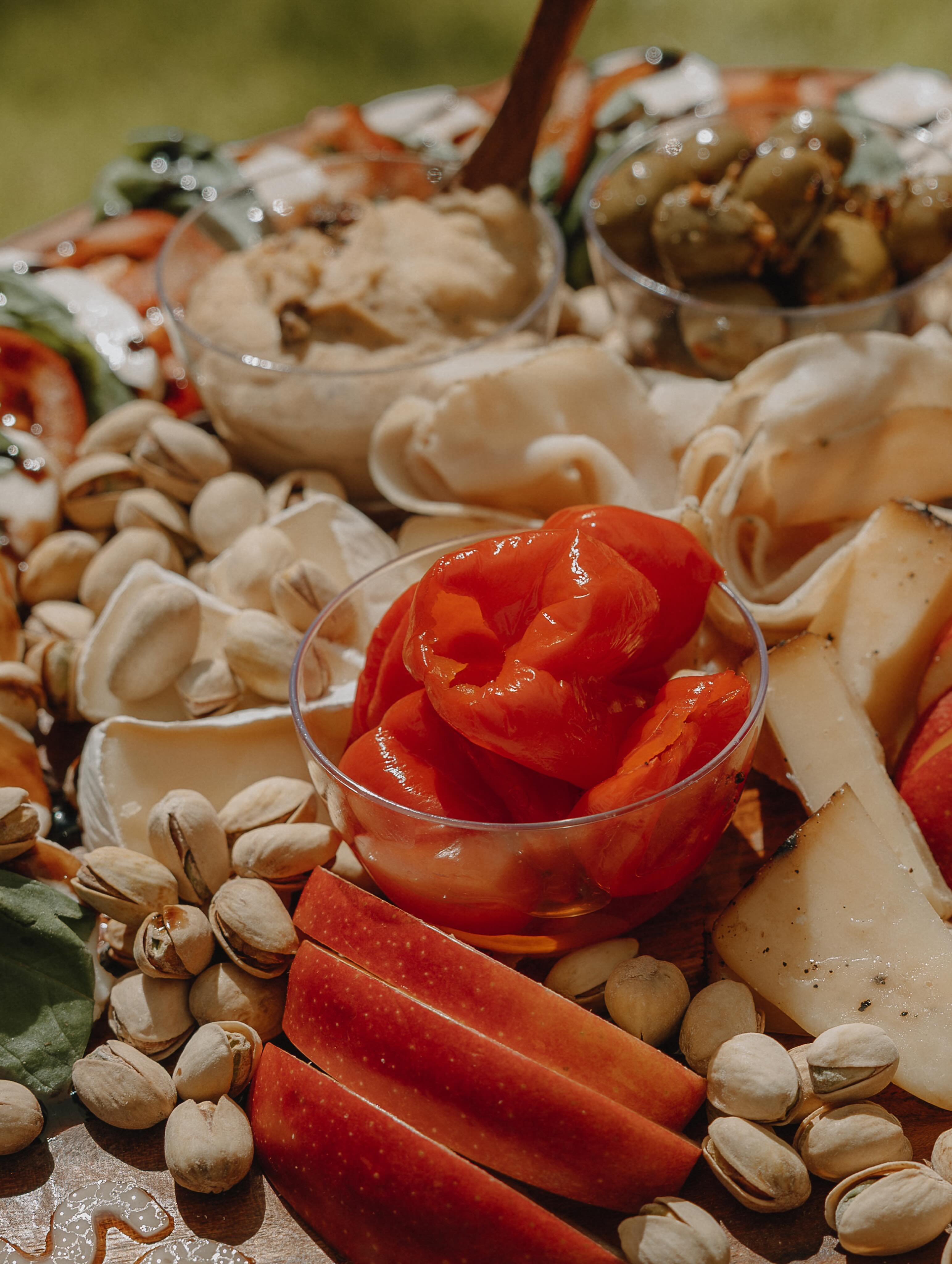 Close-up of a handmade charcuterie board with salami roses, fruit, and cheese
